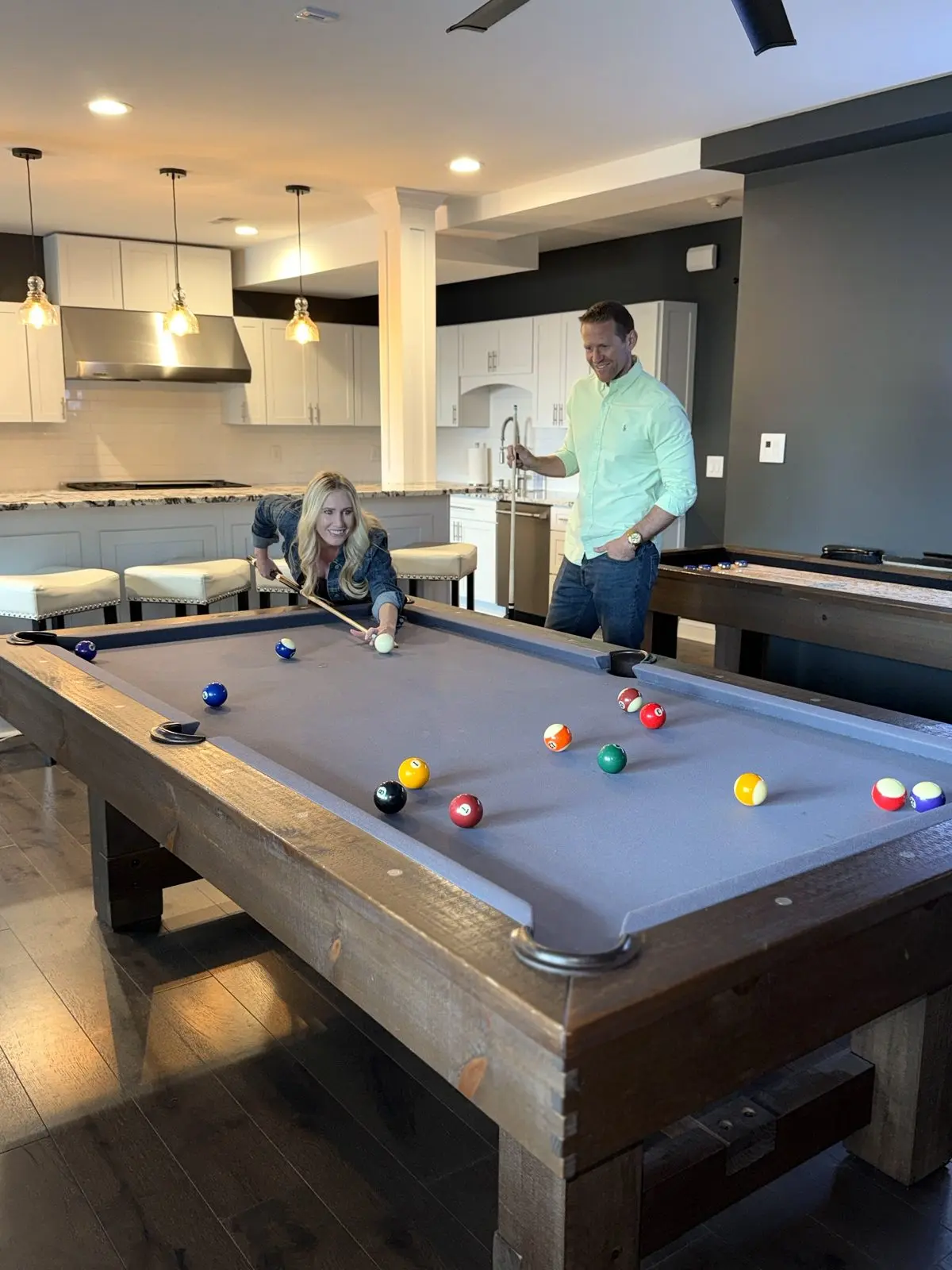 Guests enjoying a game of pool in the entertainment room
