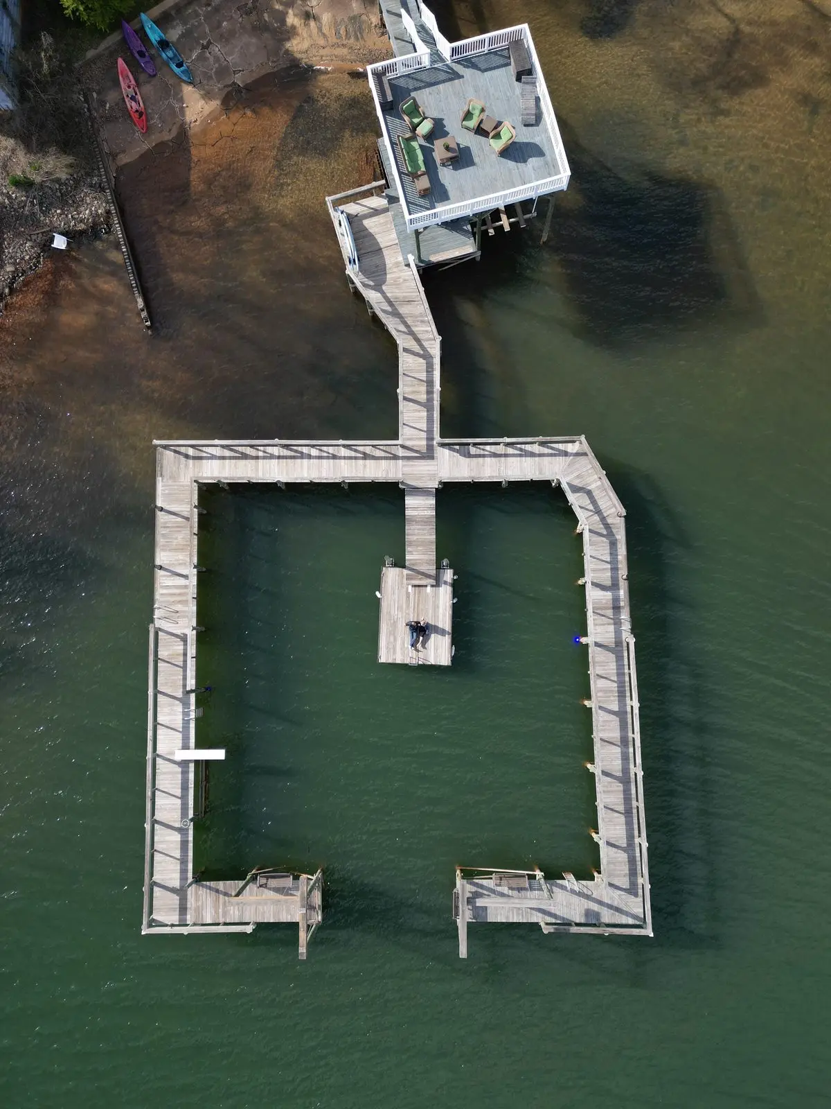 Dock with seating areas and colorful kayaks