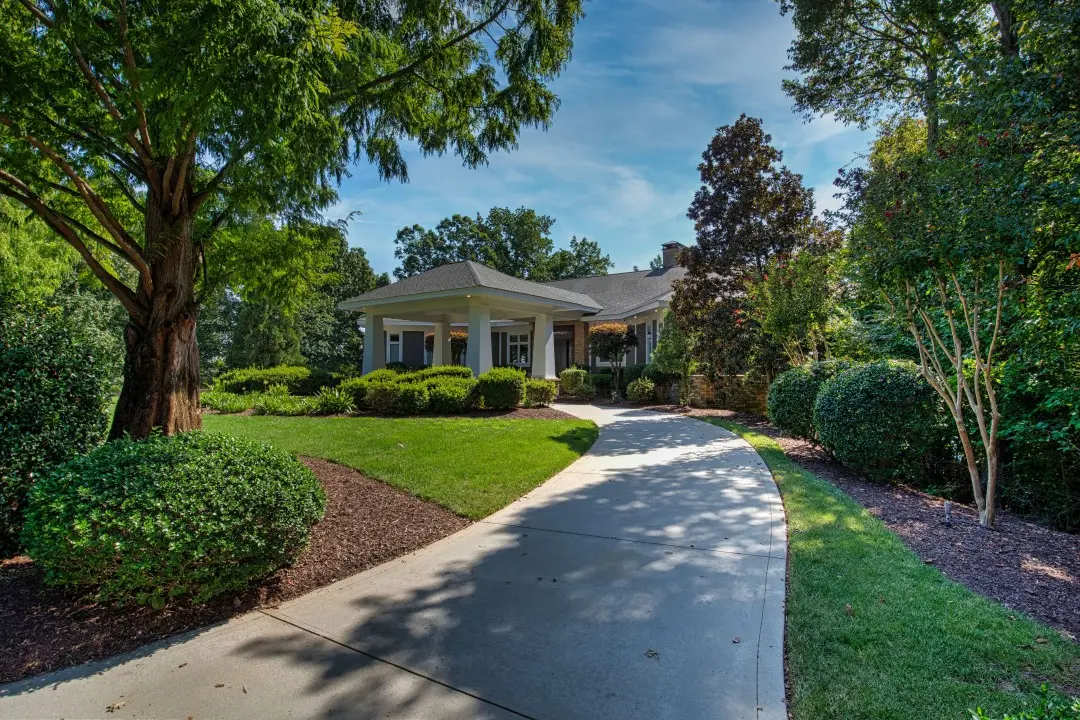 Beautifully landscaped home with winding driveway